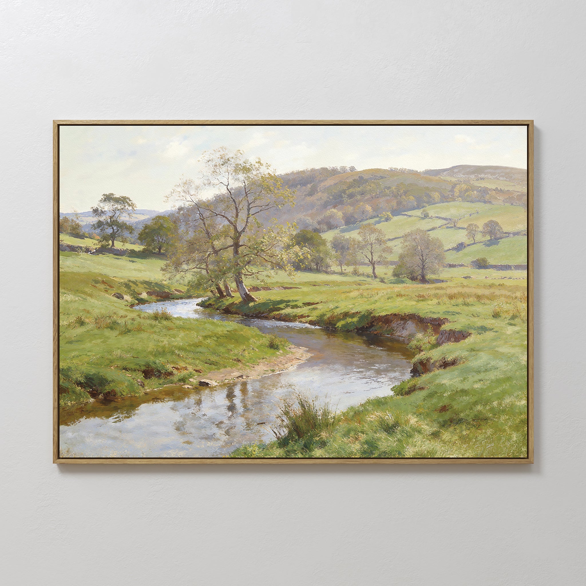 The Valley Stream Canvas Art - Horizontal displays a serene countryside with grassy fields, a winding river, scattered trees, and rolling hills under a partly cloudy sky, beautifully capturing rural charm.