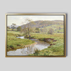 The Valley Stream Canvas Art - Horizontal showcases a peaceful countryside with a gentle river winding through green fields and rolling hills beneath a partly cloudy sky.