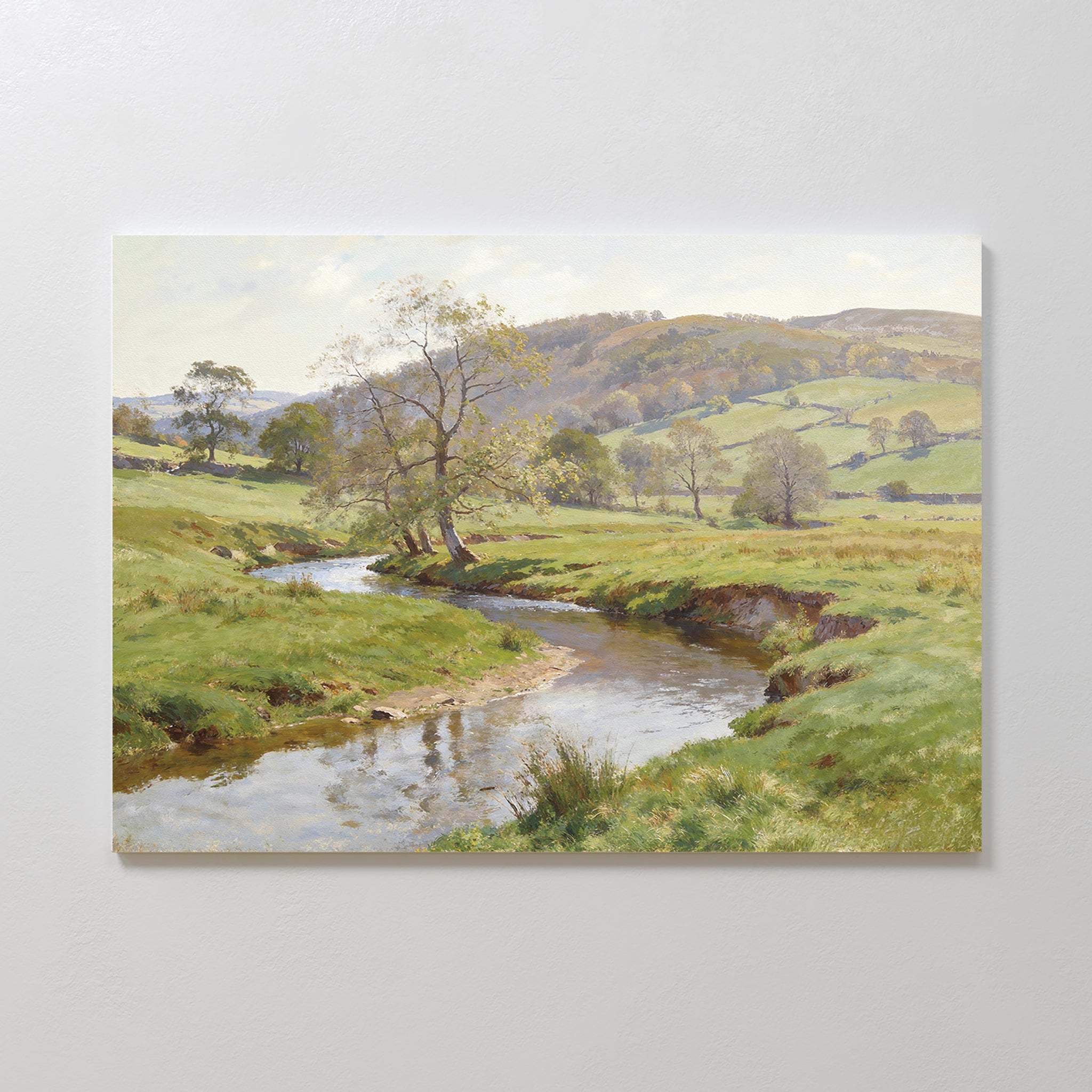 The Valley Stream Canvas Art - Horizontal features a peaceful river winding through lush fields and rolling hills beneath a soft sky, beautifully capturing the tranquility of the countryside.