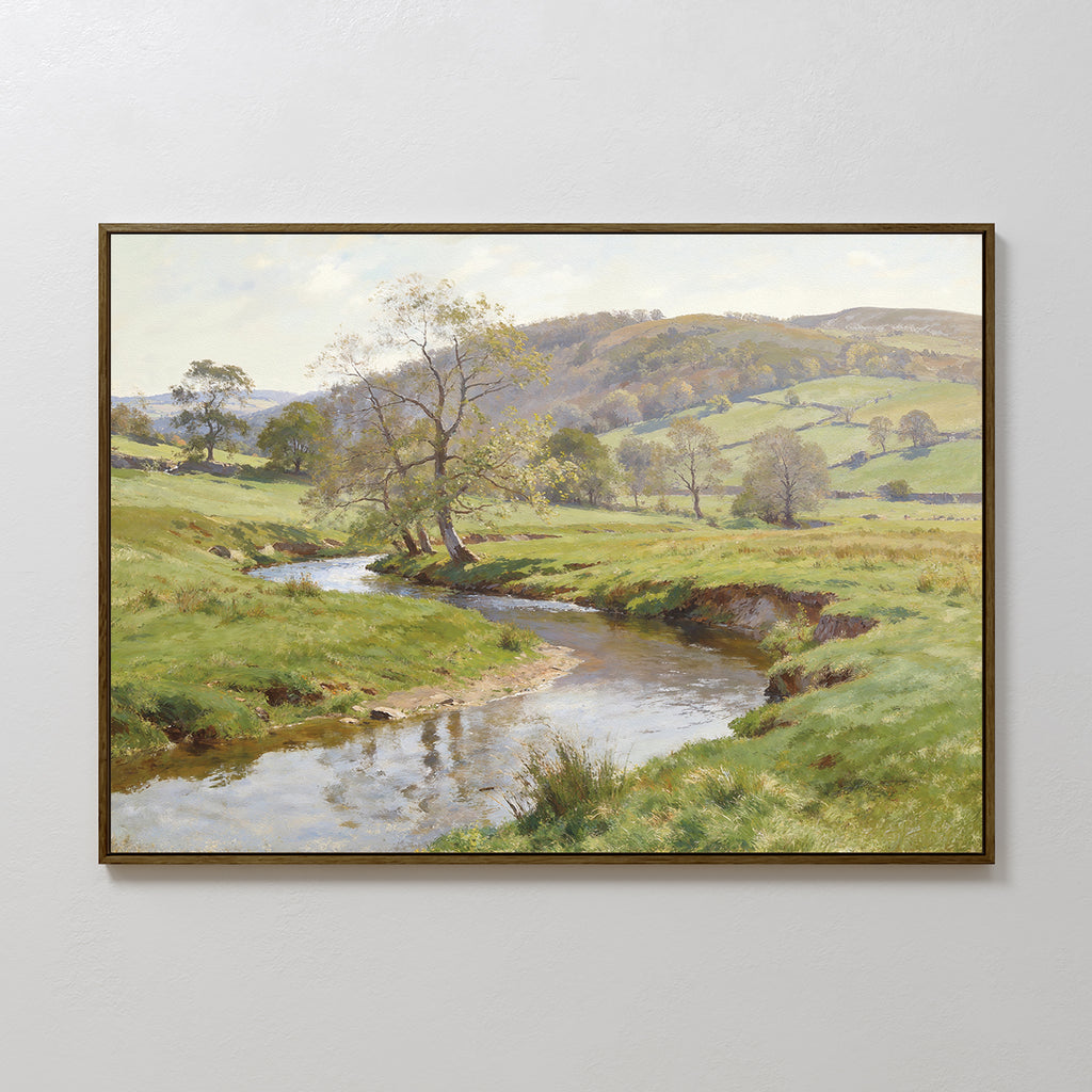 The Valley Stream Canvas Art - Horizontal features a peaceful countryside with a winding river, trees, lush green fields, and rolling hills under a partly cloudy sky, beautifully captured on framed canvas.