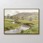 The Valley Stream Canvas Art - Horizontal features a peaceful countryside with a winding river, trees, lush green fields, and rolling hills under a partly cloudy sky, beautifully captured on framed canvas.
