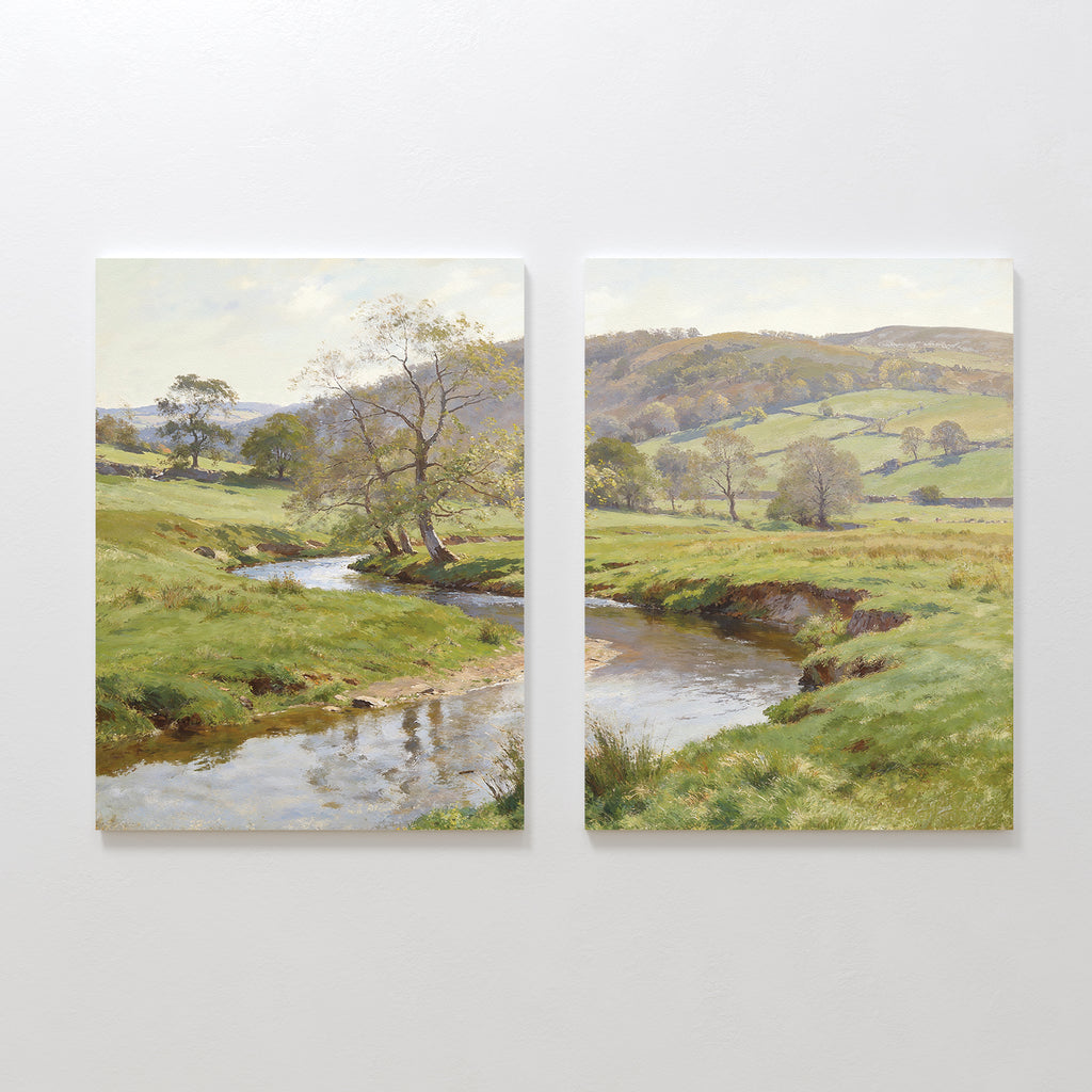 The Valley Stream - Set of 2 showcases side-by-side canvas paintings featuring a serene countryside with a winding river, lush green banks, scattered trees, and gentle hills beneath a luminous sky.