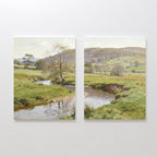 The Valley Stream - Set of 2 showcases side-by-side canvas paintings featuring a serene countryside with a winding river, lush green banks, scattered trees, and gentle hills beneath a luminous sky.