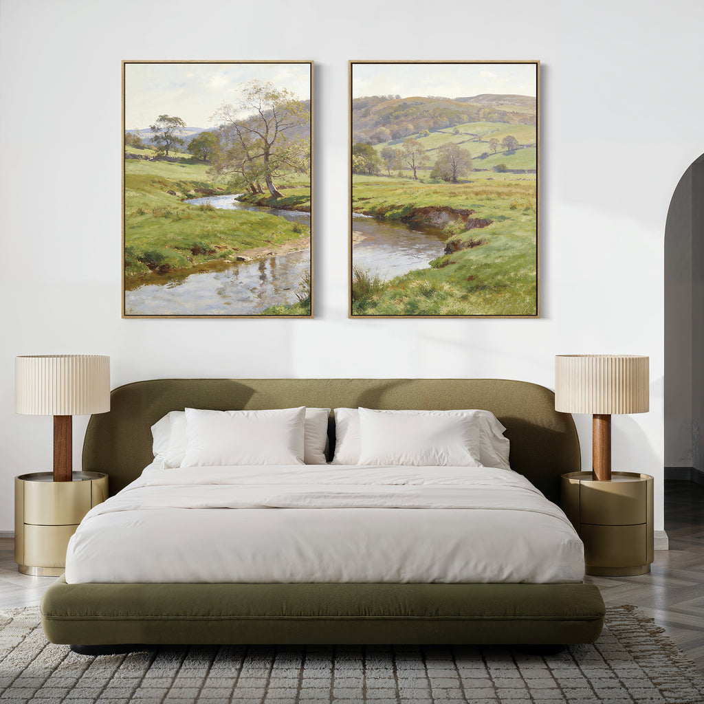 A modern bedroom features a green bed, white bedding, beige bedside tables with matching lamps, and "Valley Stream - Set of 2" landscape canvas art above the bed for a peaceful, serene ambiance.