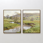 The Valley Stream - Set of 2 features two framed paintings side by side, each showing a tranquil countryside with rolling green hills, trees, and a reflective river winding through grassy meadows beneath a soft sky.