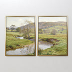 The "Valley Stream - Set of 2" features two framed prints capturing rolling green hills, a winding river, and a partly cloudy sky. Bright and serene, the countryside landscapes unfold across adjacent canvases for a harmonious display.