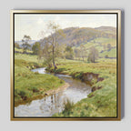 The Valley Stream Canvas Art - Square features a tranquil countryside with a winding river, grassy fields, trees, and rolling hills beneath partly cloudy skies—an ideal accent for spaces seeking serene beauty.
