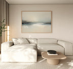 A modern living room with a light beige sectional, a square wooden coffee table with a dark bowl, and beige curtains, highlighted by the Veiled Estuary Canvas Art - Horizontal above the sofa.