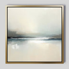 Veiled Estuary Canvas Art - Square: A minimalist abstract painting in a gold frame, presenting soft cream, gray, and blue hues that evoke a calm seascape or horizon with gentle reflections beneath a cloudy sky. Contemporary wall art for serene spaces.