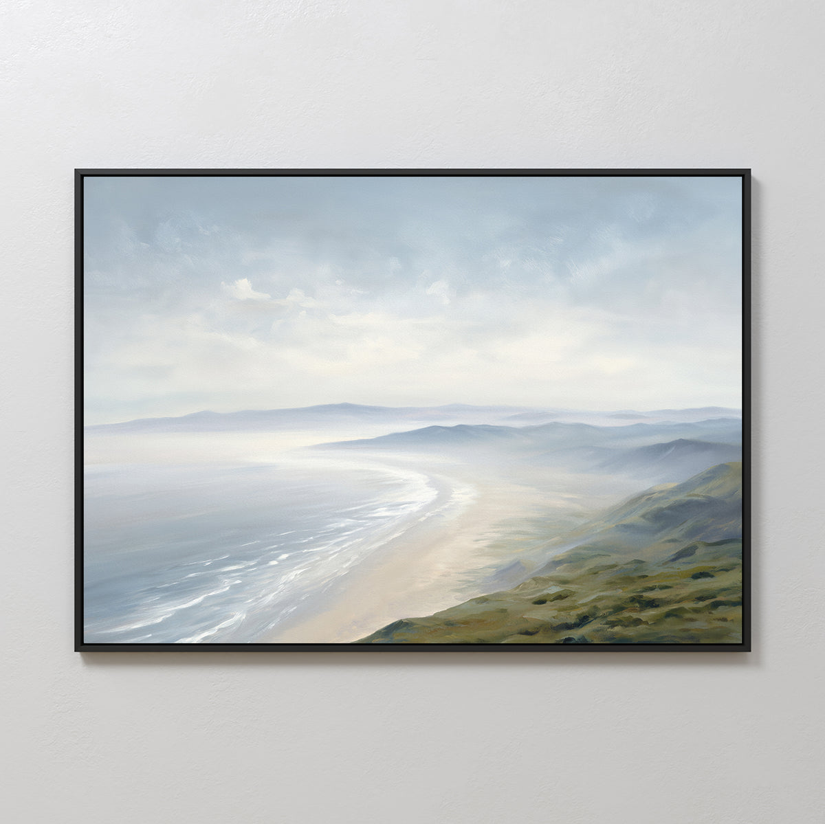 Veiled Shores Canvas Art - Horizontal: a framed canvas depicting gentle waves, sandy beach, and rolling green hills under a soft cloudy sky—a serene coastal landscape, perfect for any white wall.