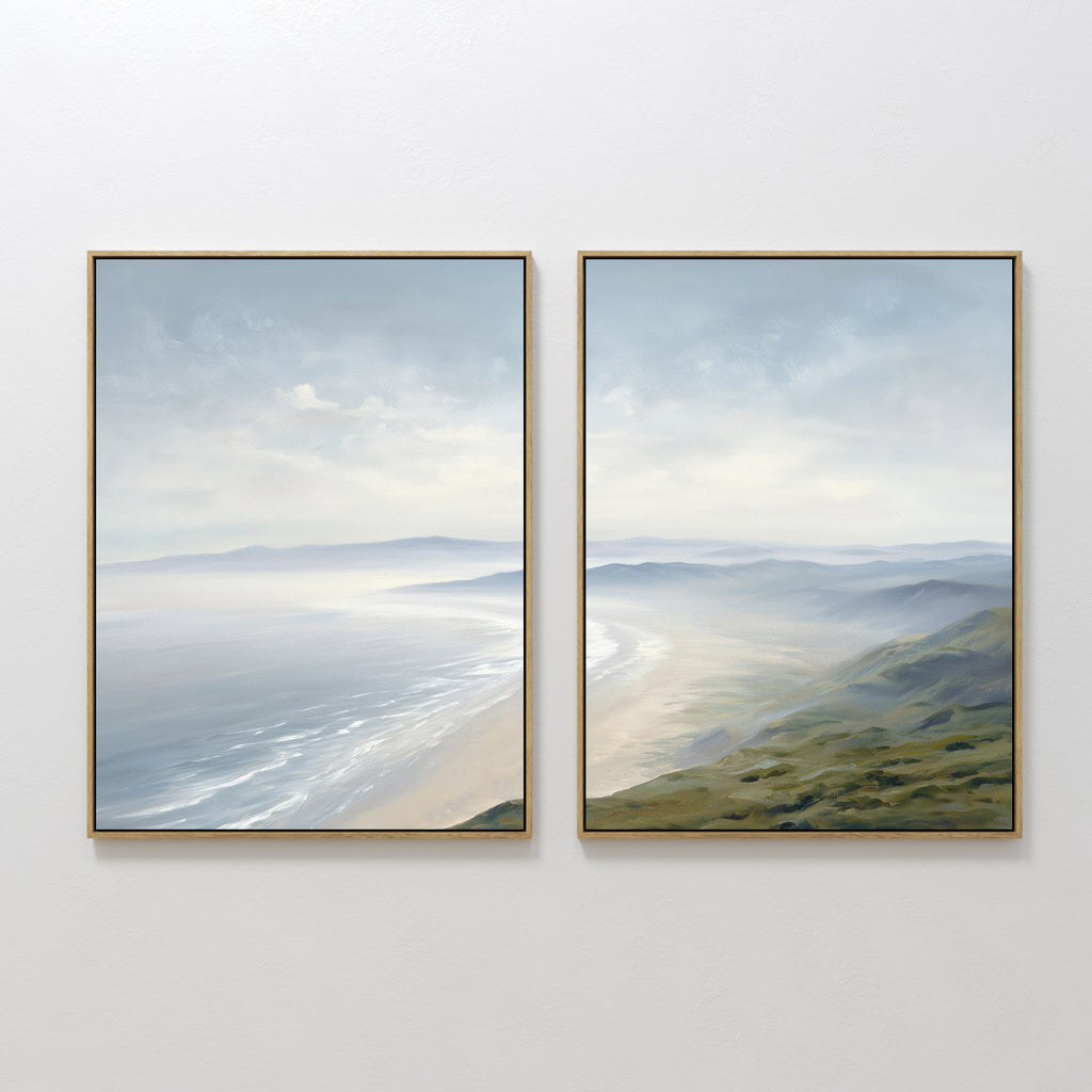 The "Veiled Shores - Set of 2" features framed wall art with serene coastal scenes—sandy beach, gentle waves, and rolling green hills under a cloudy sky—using soft, muted colors for a peaceful atmosphere.