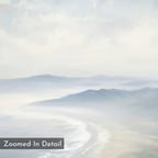 The Veiled Shores Canvas Art - Square features a soft, pastel coastal landscape with misty mountains, a curving shoreline, gentle waves, and "Zoomed In Detail" text in the bottom left for a serene, dreamy touch.