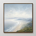 The Veiled Shores Canvas Art - Square showcases a misty coastline with gentle waves, sandy shore, and distant hills beneath a cloudy sky—perfect coastal landscape wall art for any room.