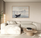 A minimalist living room features a cream sectional, light wood coffee table, and the Venetian Stillness Canvas Art - Horizontal displayed above the sofa. Neutral tones and soft natural lighting complete the serene atmosphere.
