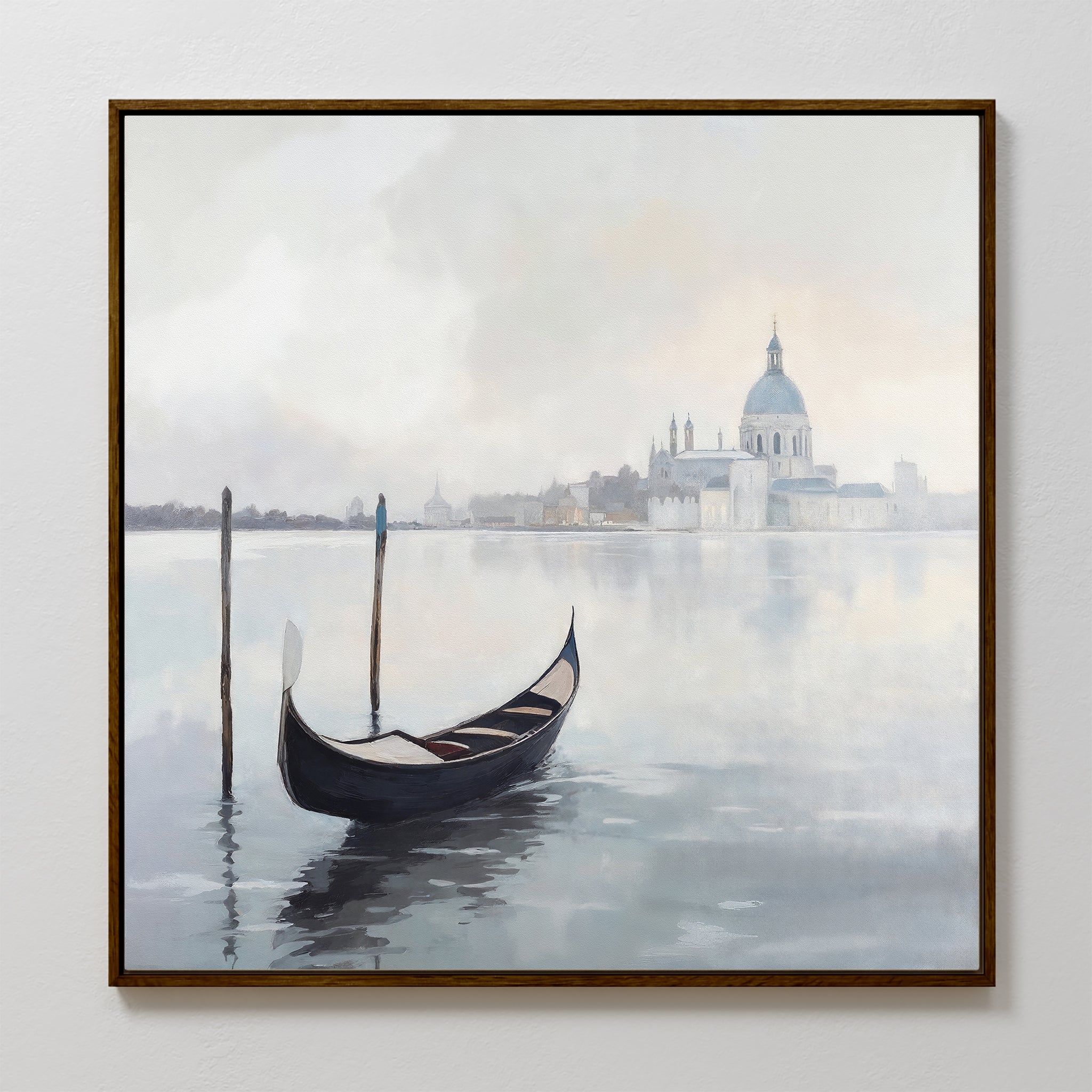 The Venetian Stillness Canvas Art - Square depicts a gondola gliding on tranquil waters, misty buildings, and a domed cathedral, capturing the serene European charm of Venice in a framed canvas print.