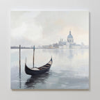 The Venetian Stillness Canvas Art - Square features a gondola gliding on calm waters with misty buildings and a domed cathedral in the background, captured in soft, muted colors for a peaceful, timeless European charm.