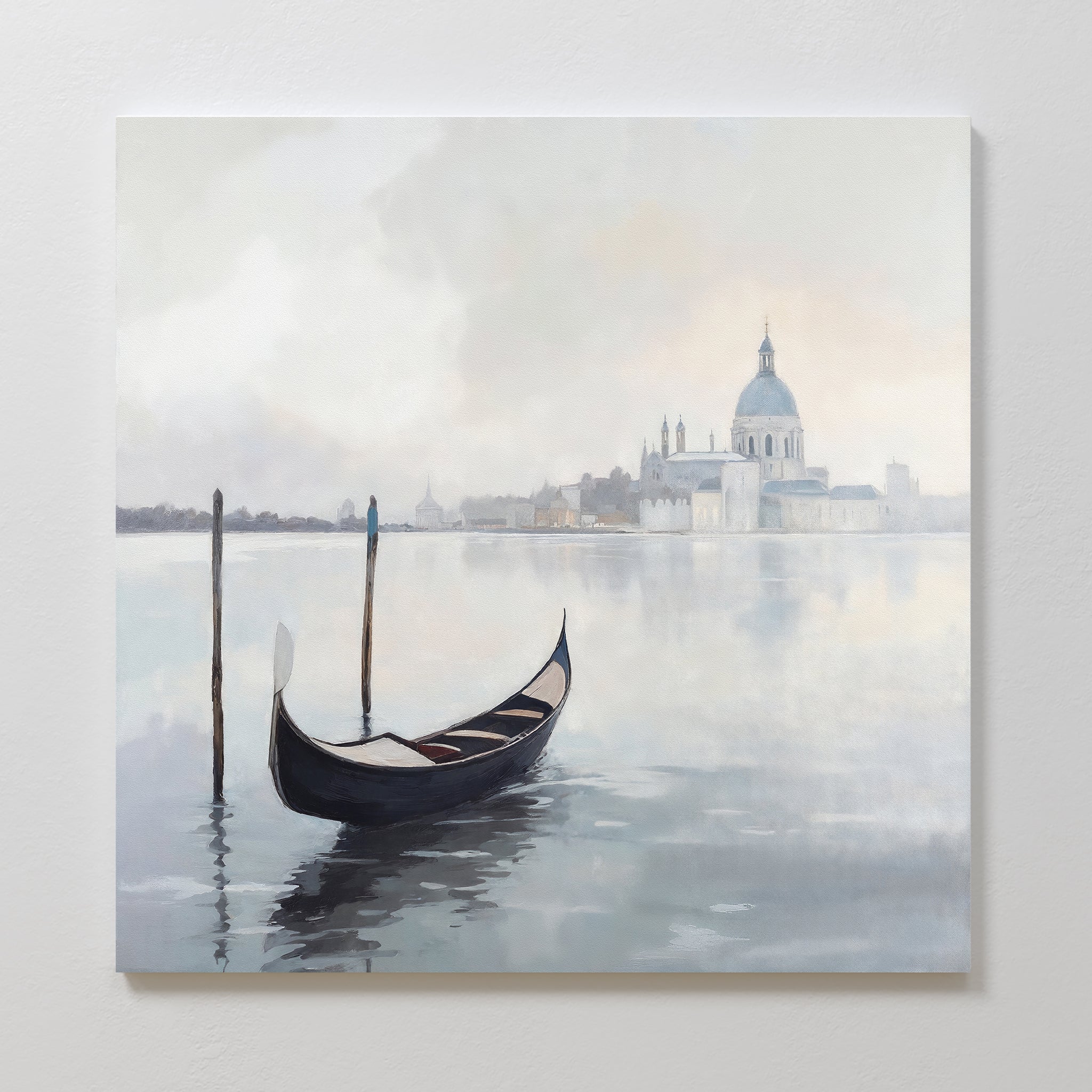 The Venetian Stillness Canvas Art - Square features a gondola gliding on calm waters with misty buildings and a domed cathedral in the background, captured in soft, muted colors for a peaceful, timeless European charm.