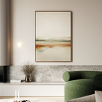 A modern living room features a green curved sofa, minimalist décor, a small vase with dried flowers, and the Earthly Hues Abstract Canvas Art—a large abstract landscape in earthy tones—hanging above a light stone bench.