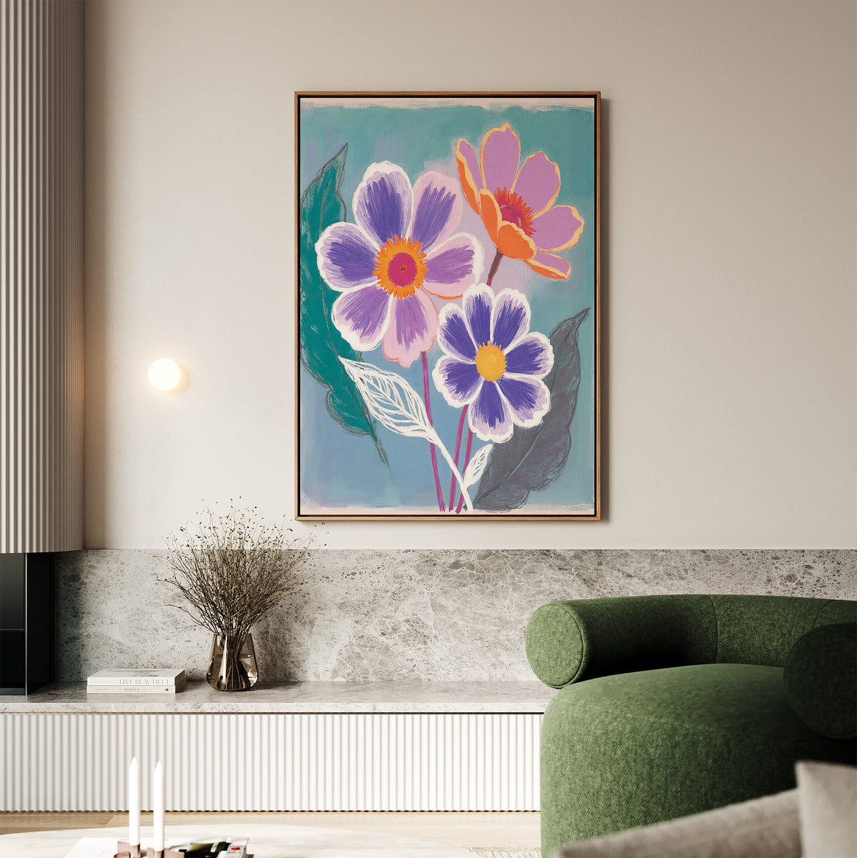 A modern living room with a green curved sofa, marble shelf, and the Vibrant Petals Canvas Art - Vertical—a bold painting of three abstract flowers in purple, pink, and orange—hanging on a light wall.