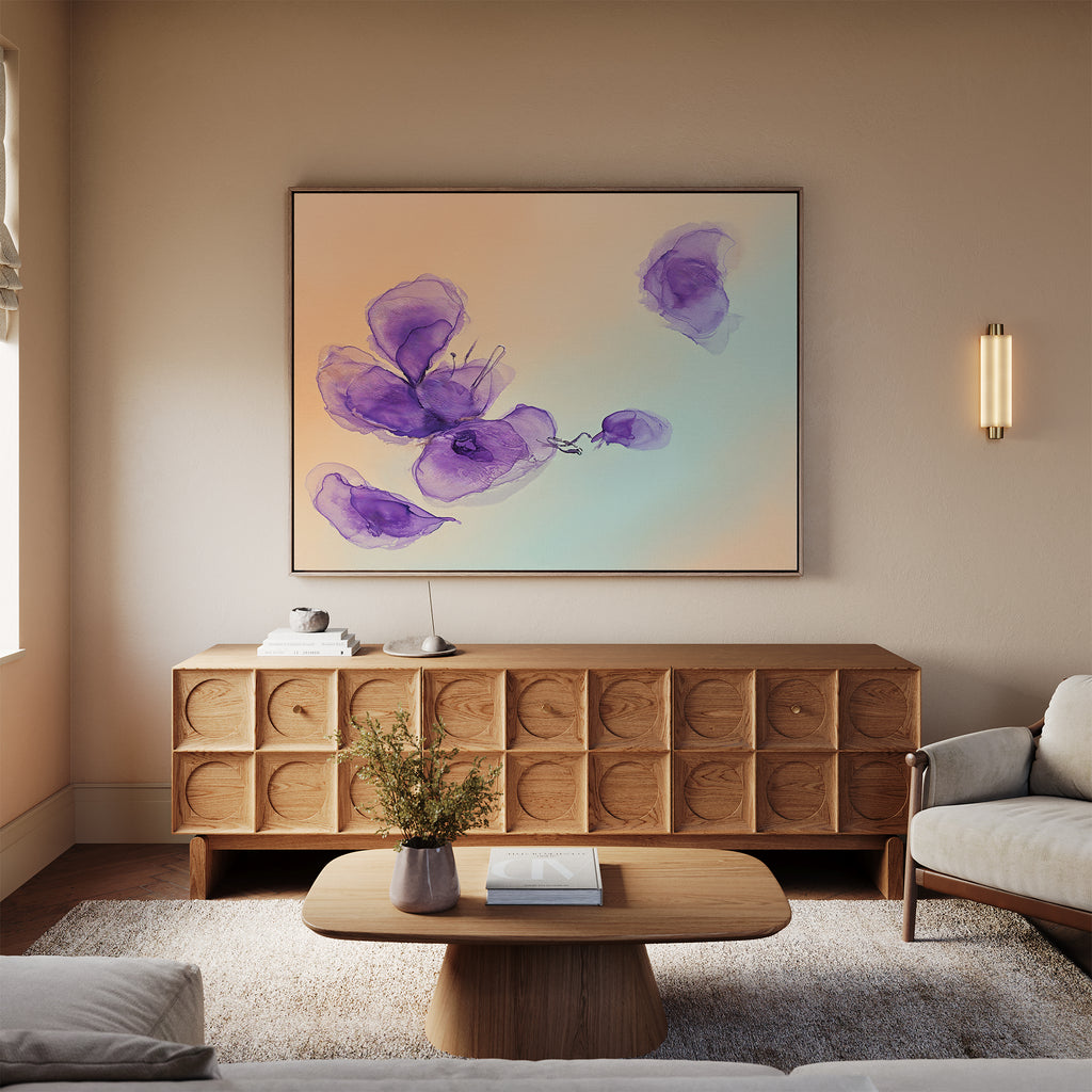 A modern living room featuring the Violet Dreams Canvas Art - Horizontal on the wall, a wooden sideboard, beige sofa, light wood coffee table with a vase of flowers, and calm neutral-toned decor.