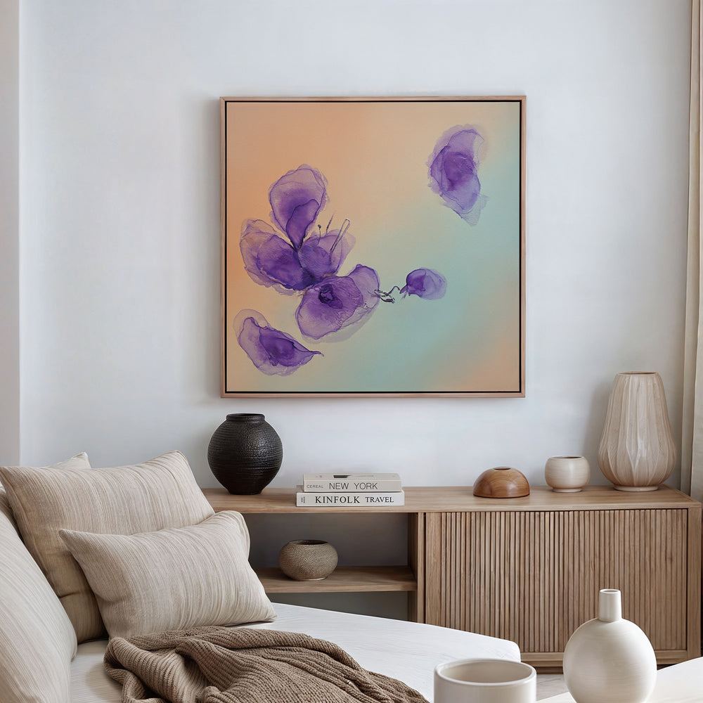 A modern living room with a beige sofa, neutral cushions, and a wooden sideboard decorated with vases and books. Above the sideboard hangs the Violet Dreams Canvas Art - Square, adding botanical charm with its abstract floral design.