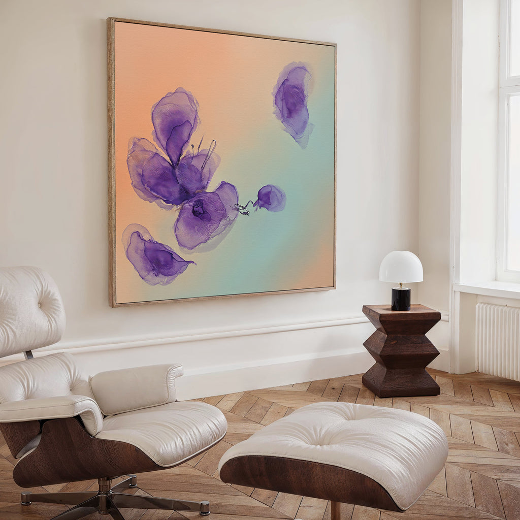 A modern living room with a white lounge chair and ottoman, a wooden side table with a white lamp, and Violet Dreams Canvas Art - Square—a large abstract piece featuring purple flowers on a peach and green gradient background.