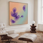 A modern living room with a white lounge chair and ottoman, a wooden side table with a white lamp, and Violet Dreams Canvas Art - Square—a large abstract piece featuring purple flowers on a peach and green gradient background.