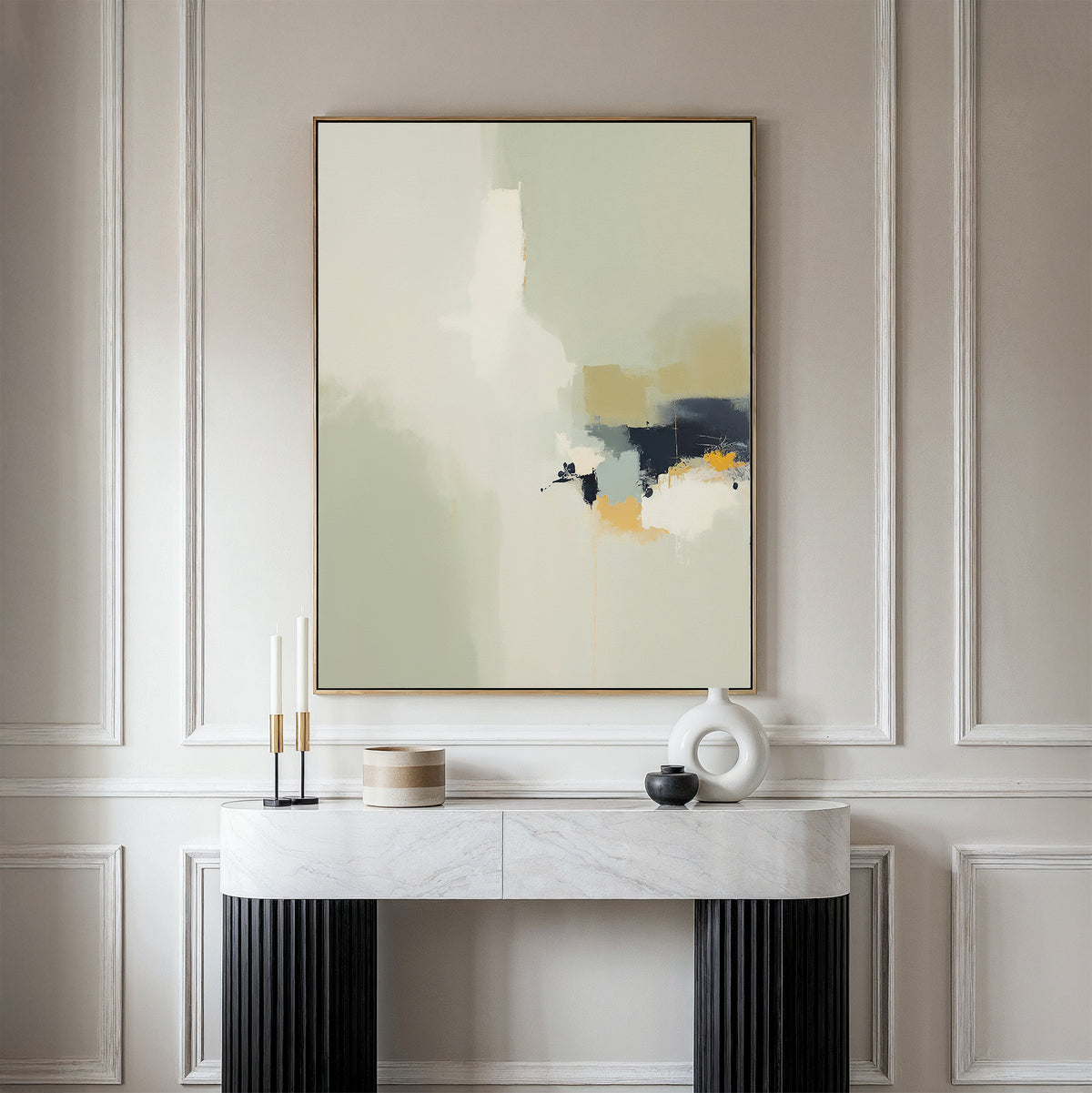 A modern console table with decor sits against a light-paneled wall, topped by the Weathered Composition Canvas Art - Vertical, a large abstract print in soft beige, white, navy, and gold tones that exude modern elegance.
