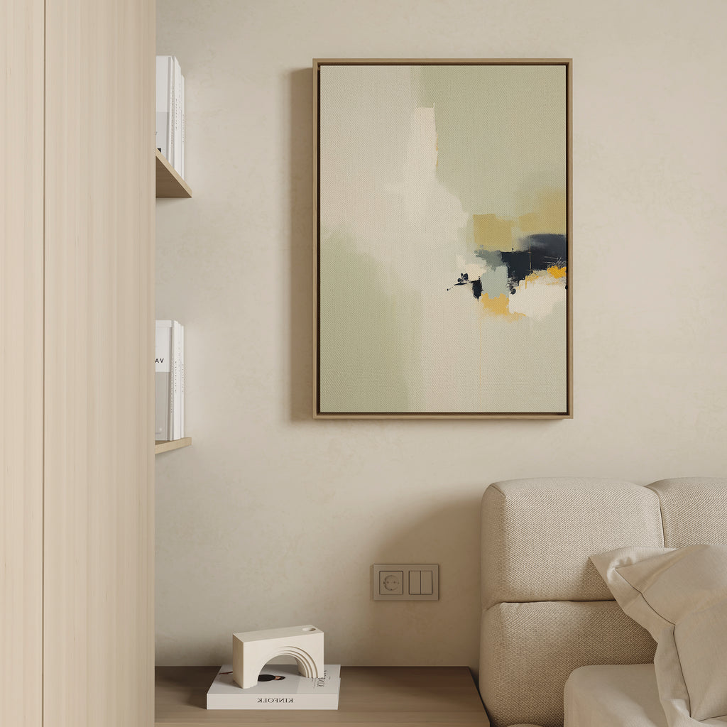 A minimalist living room corner with a beige sofa, a chic white decor piece, books on wall shelves, and the Weathered Composition Canvas Art—an abstract vertical painting in neutral tones with subtle black and yellow accents.
