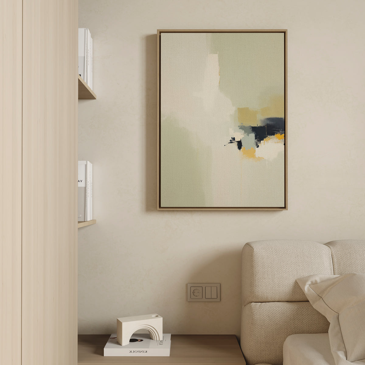 A minimalist living room corner with a beige sofa, a chic white decor piece, books on wall shelves, and the Weathered Composition Canvas Art—an abstract vertical painting in neutral tones with subtle black and yellow accents.