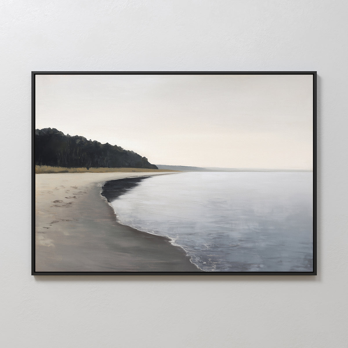 Weathered Shore Canvas Art - Horizontal features a serene beach with gentle waves, a distant tree-lined coast on the left, and a soft sky above. This framed coastal wall art adds peaceful, minimalist charm to any space.
