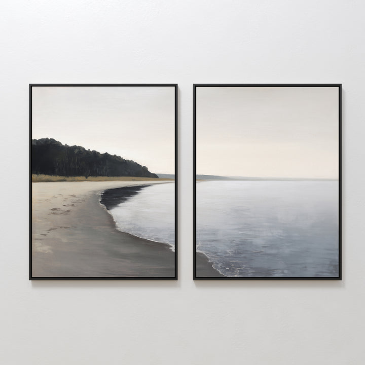 The Weathered Shore - Set of 2 features framed shoreline art with calm waters, sandy beach, and distant trees beneath an overcast sky. Its minimal design and soft hues bring peaceful Nordic Park vibes to any space.