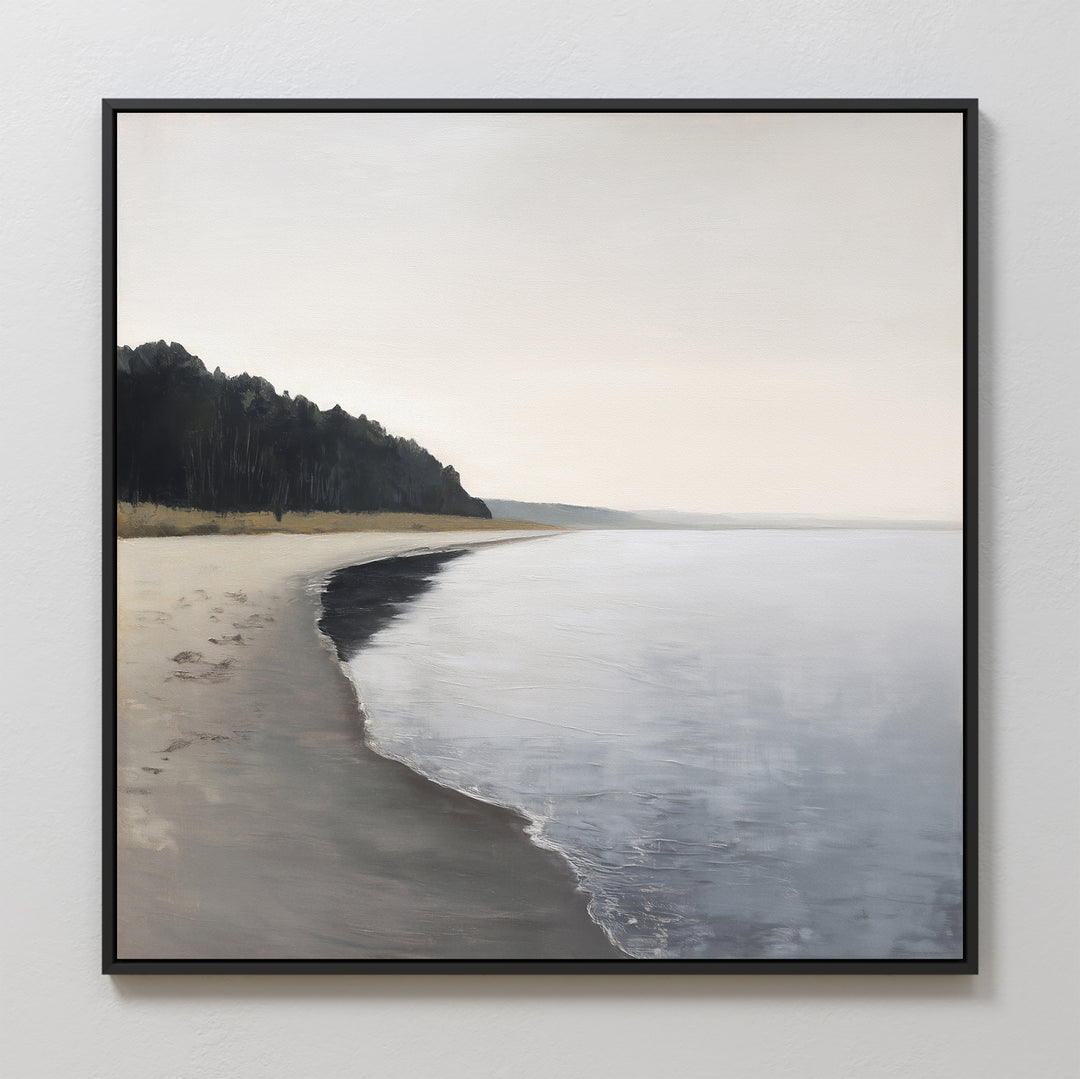 Weathered Shore Canvas Art - Square features a framed coastal scene of a tranquil, empty beach with gentle waves and distant dark trees beneath an overcast sky, creating peaceful and serene wall decor.