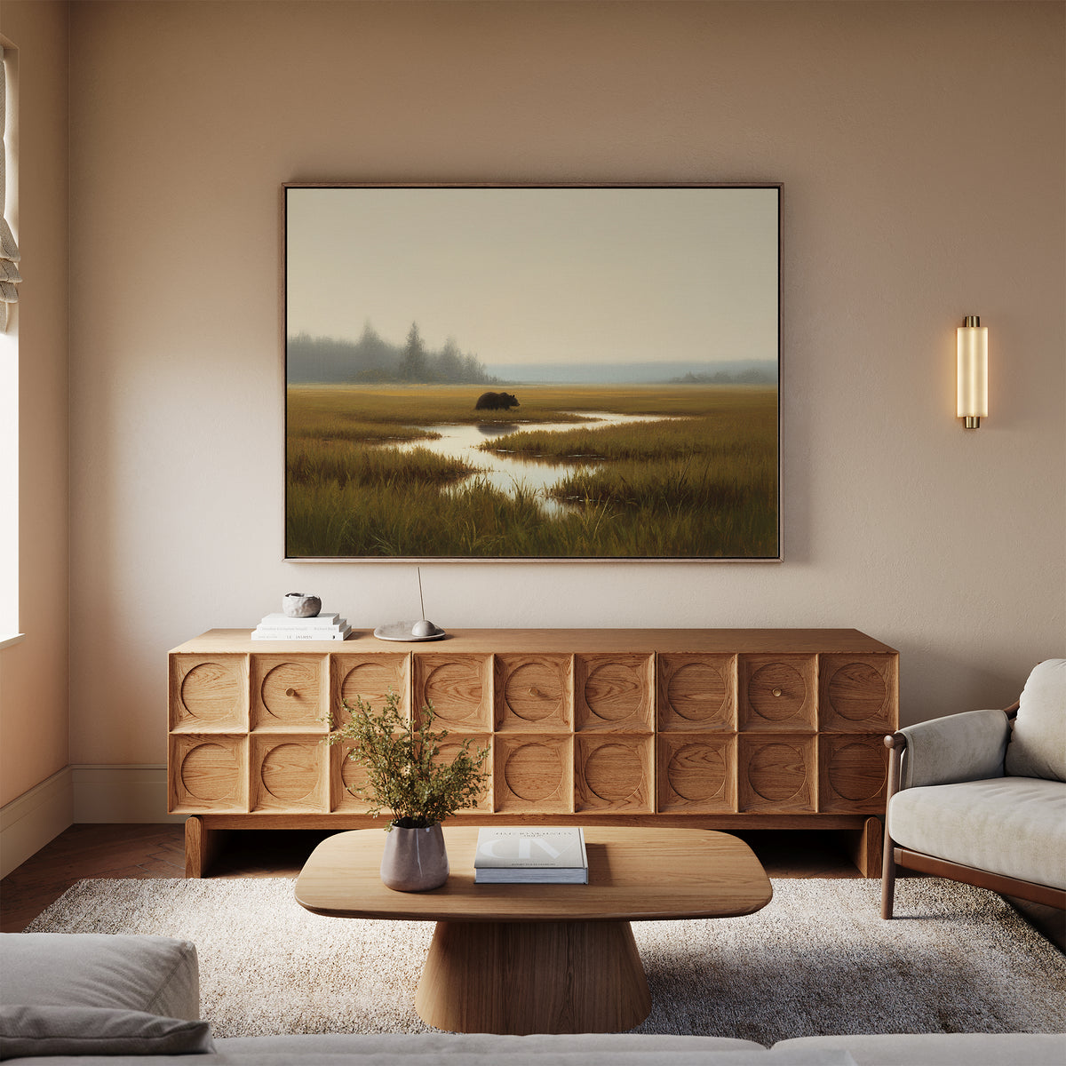 A cozy living room with a light sofa, wooden coffee table, sideboard, and the Wetland Bear Canvas Art - Horizontal on the wall. Neutral tones and a wall-mounted light fixture add warmth to the space.