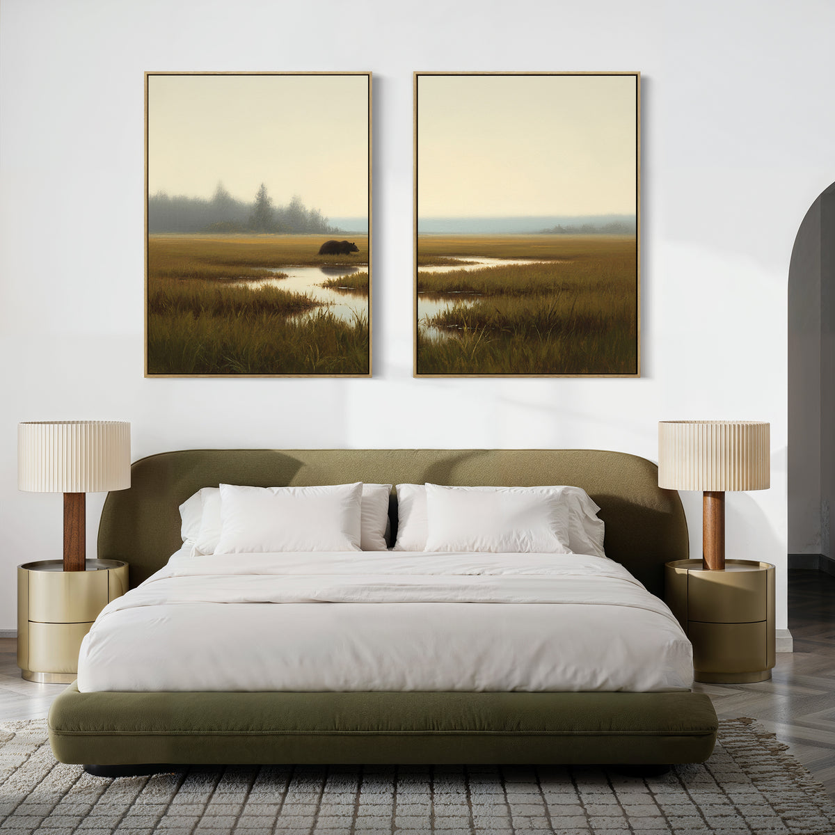 A modern bedroom with an olive green bed, white bedding, two round gold nightstands with pleated lamps, and "Wetland Bear - Set Of 2" landscape paintings hanging above the bed.
