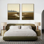 A modern bedroom with an olive green bed, white bedding, two round gold nightstands with pleated lamps, and "Wetland Bear - Set Of 2" landscape paintings hanging above the bed.