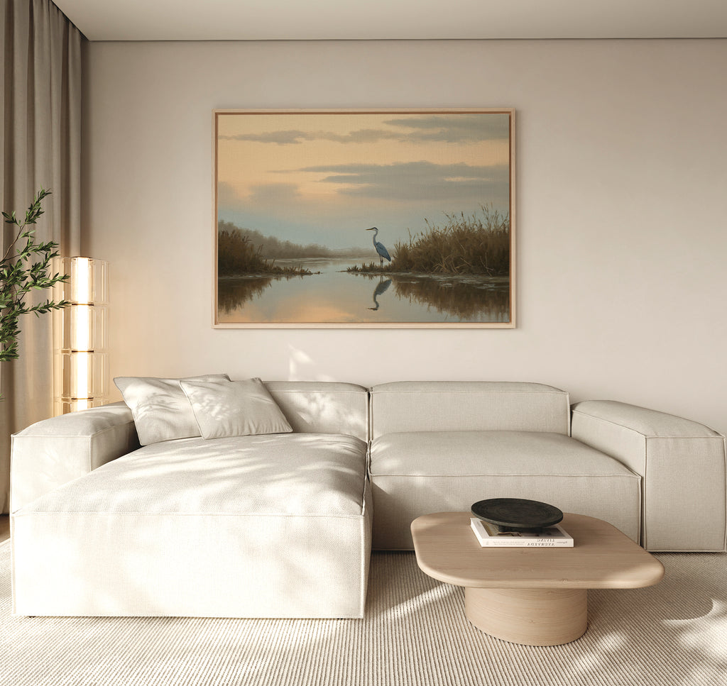 A modern living room with a light beige sectional, wooden coffee table, and striking Wetland Heron Canvas Art - Horizontal—Nordic Park marsh landscape decor—illuminated by soft natural light drifting through curtains.