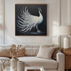 A cozy living room features a beige sofa, neutral cushions, a side table with a lamp, dried flowers, and elegant wall art—a White Peacock Display Canvas Art - Square—displayed above the sofa.