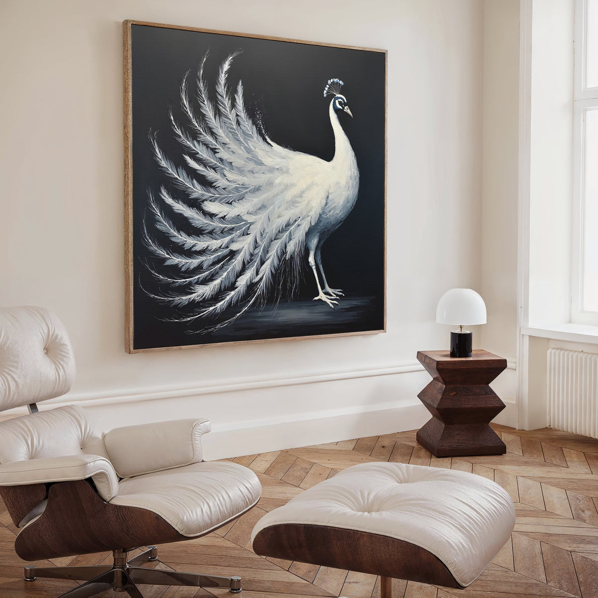 A modern living room with a white lounge chair and ottoman, wooden side table with a white lamp, and the White Peacock Display Canvas Art - Square as elegant wall decor. Light wood herringbone floor and neutral walls complete the look.