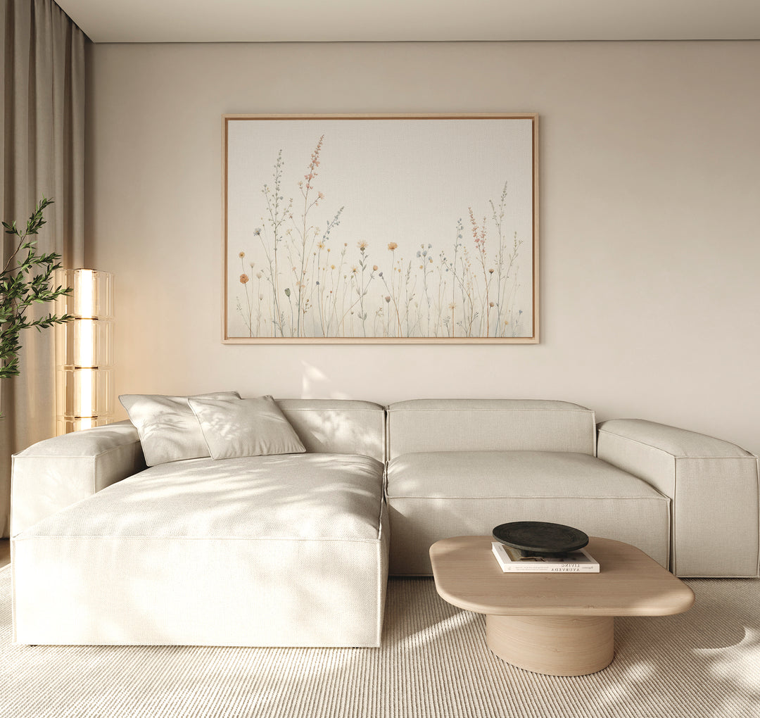 A living room featuring a large couch and the Wildflower Dreams Canvas Art - Horizontal, adding botanical wall art and Nordic-inspired elegance to the space.