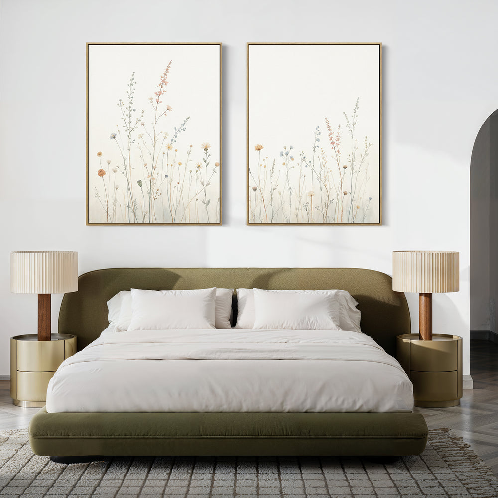 A modern bedroom with an olive green bed, white bedding, tan nightstands with matching lamps, and the Wildflower Dreams - Set of 2 botanical wall art above the headboard creates a calming ambiance.