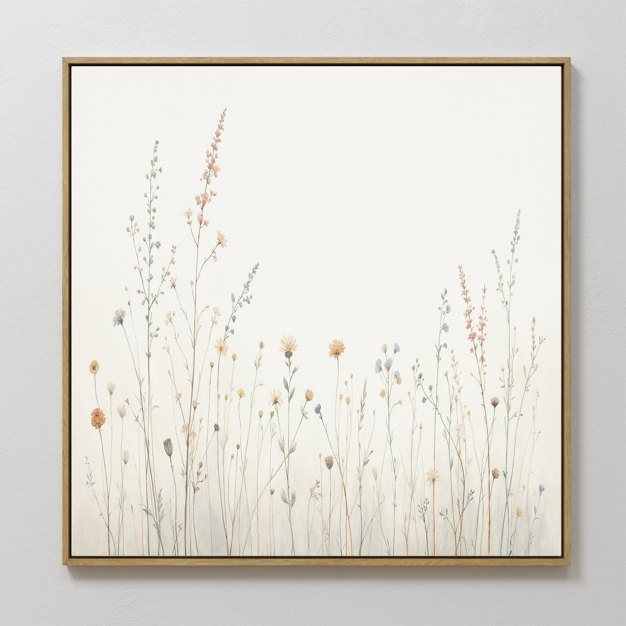The Wildflower Dreams Canvas Art - Square features delicate, pastel wildflowers and grasses on a light background. Its minimalistic design brings a calm, natural vibe to any space.