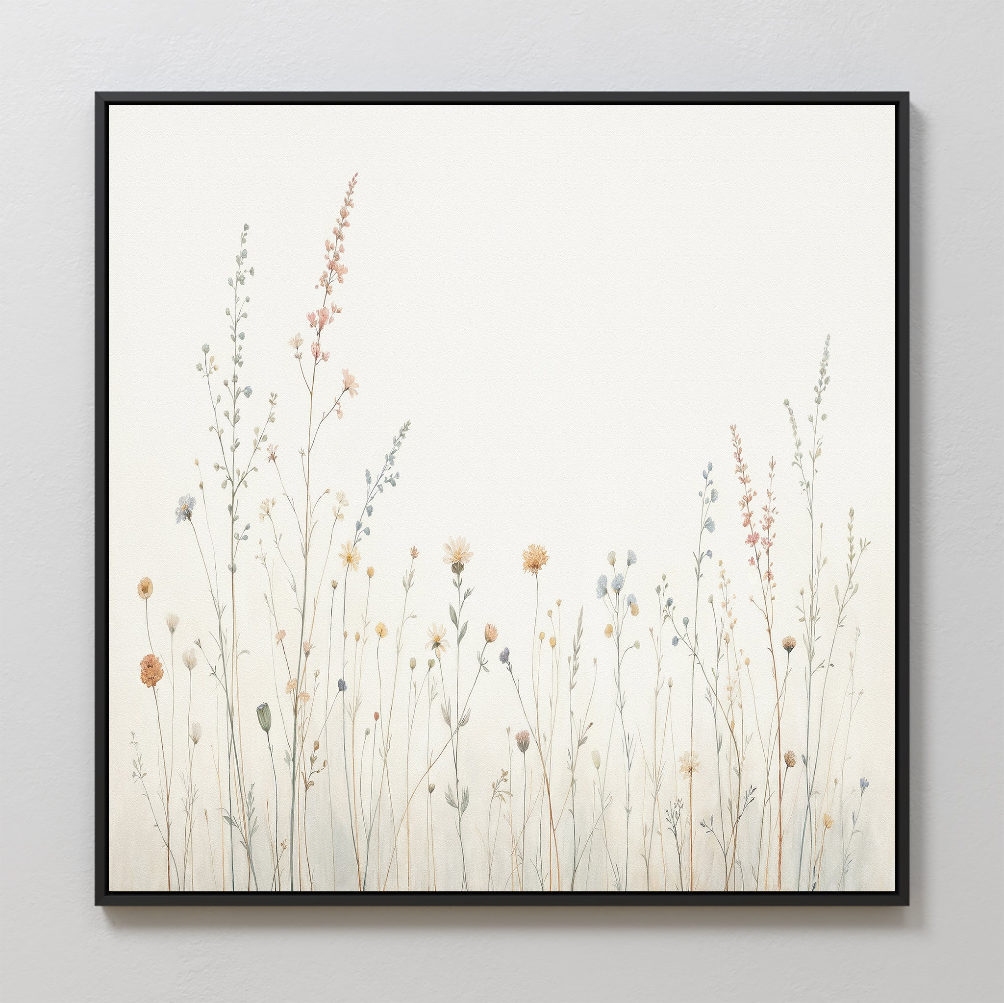 The Wildflower Dreams Canvas Art - Square showcases delicate pastel wildflowers and grasses on a white background with a sleek black frame, inspired by Nordic parks—ideal for bringing a calm, airy vibe to your space.
