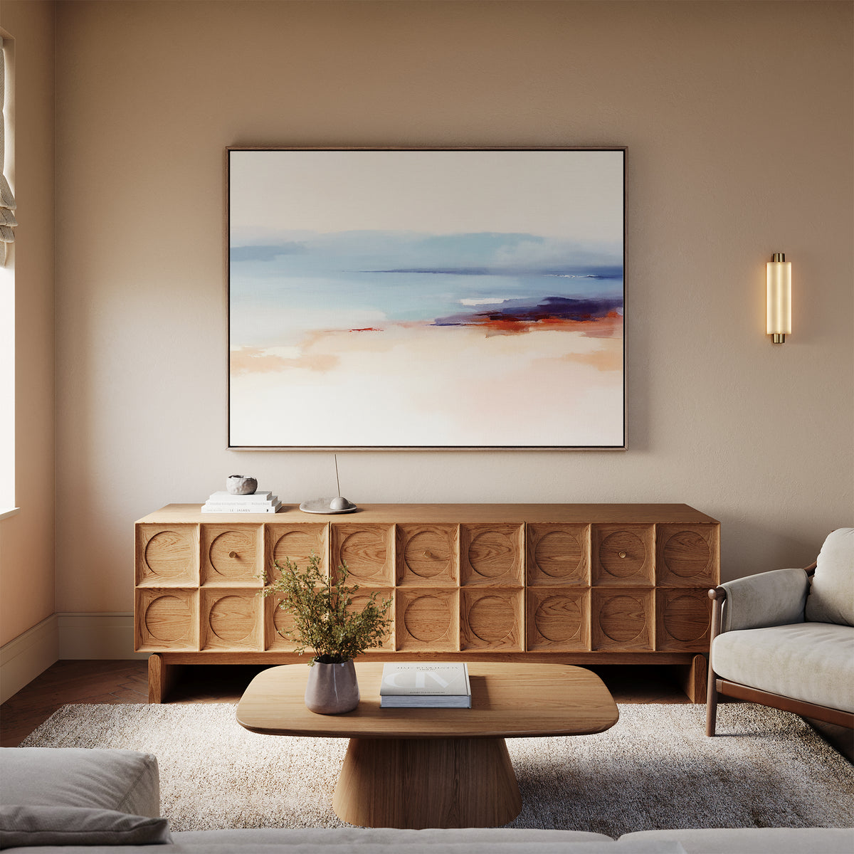 A modern living room with a wooden coffee table, textured sideboard, beige sofa, and Windswept Coastline Canvas Art - Horizontal above. Soft neutrals and fresh flowers on the table enhance the calm, inviting atmosphere.