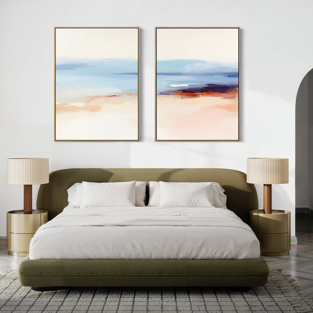 A modern bedroom featuring an olive green upholstered bed with white bedding, two beige nightstands and matching lamps, and the "Windswept Coastline - Set Of 2" serene pastel wall art above the bed.