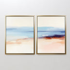 The "Windswept Coastline - Set Of 2" features abstract gold-framed prints with soft blue, beige, peach, and white tones—serene wall art for anyone seeking elegant coastal style in a modern interior.