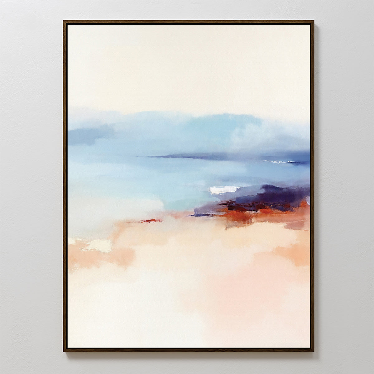 Windswept Coastline Canvas Art - Vertical features soft, blurred colors: pale blue and white on top evoke sky or water, while warm peach and brown tones below suggest a shoreline. Finished in a thin black frame for a serene coastal look.