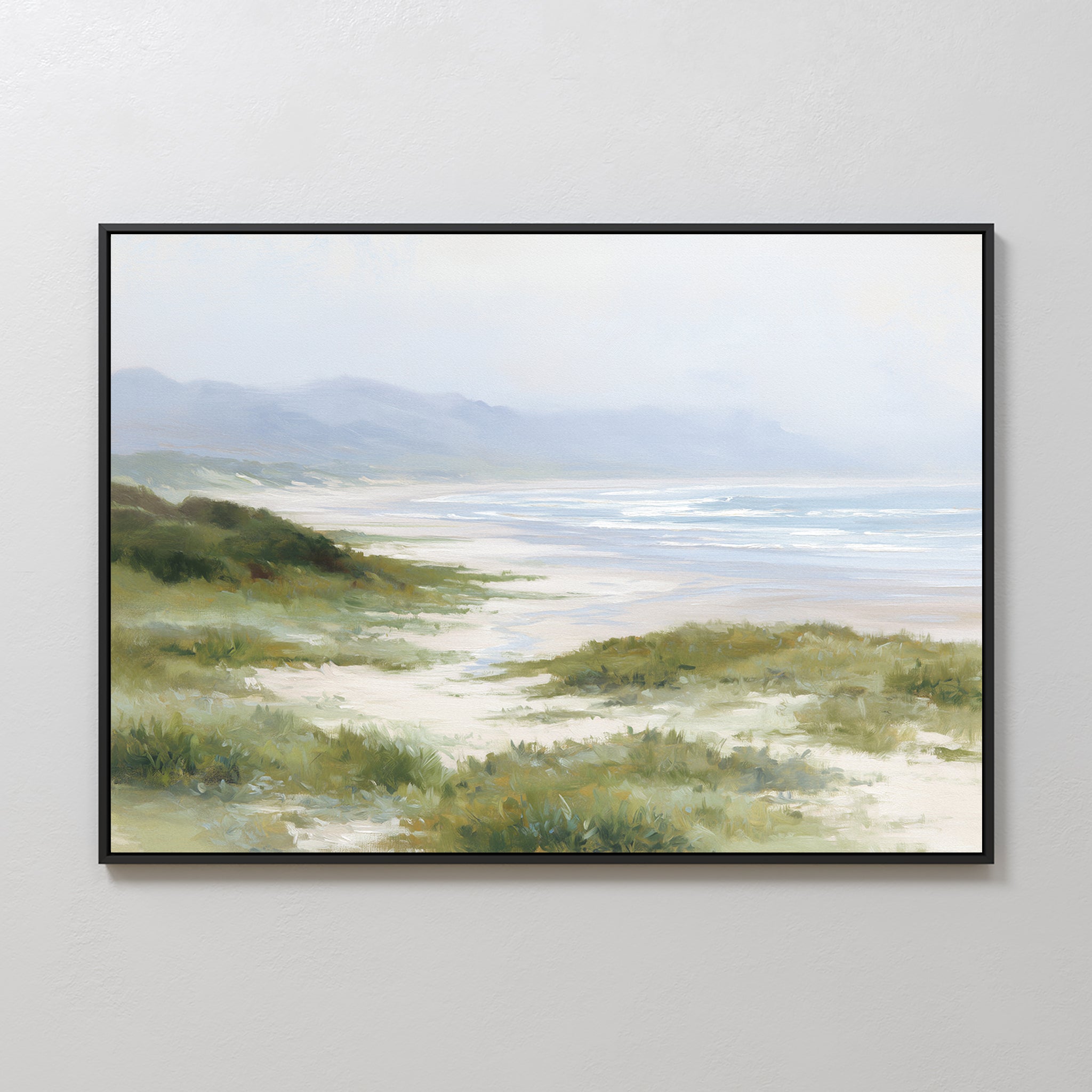 The Windswept Dunes Canvas Art - Horizontal showcases grassy sand dunes, a sandy beach, gentle waves, and misty mountains beneath a cloudy sky for a calming coastal atmosphere.