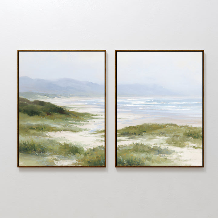 The "Windswept Dunes - Set of 2" features calming coastal scenes with grassy dunes, sandy paths, gentle waves, and distant mountains under a soft sky in muted greens, blues, and sandy tones for a peaceful atmosphere.