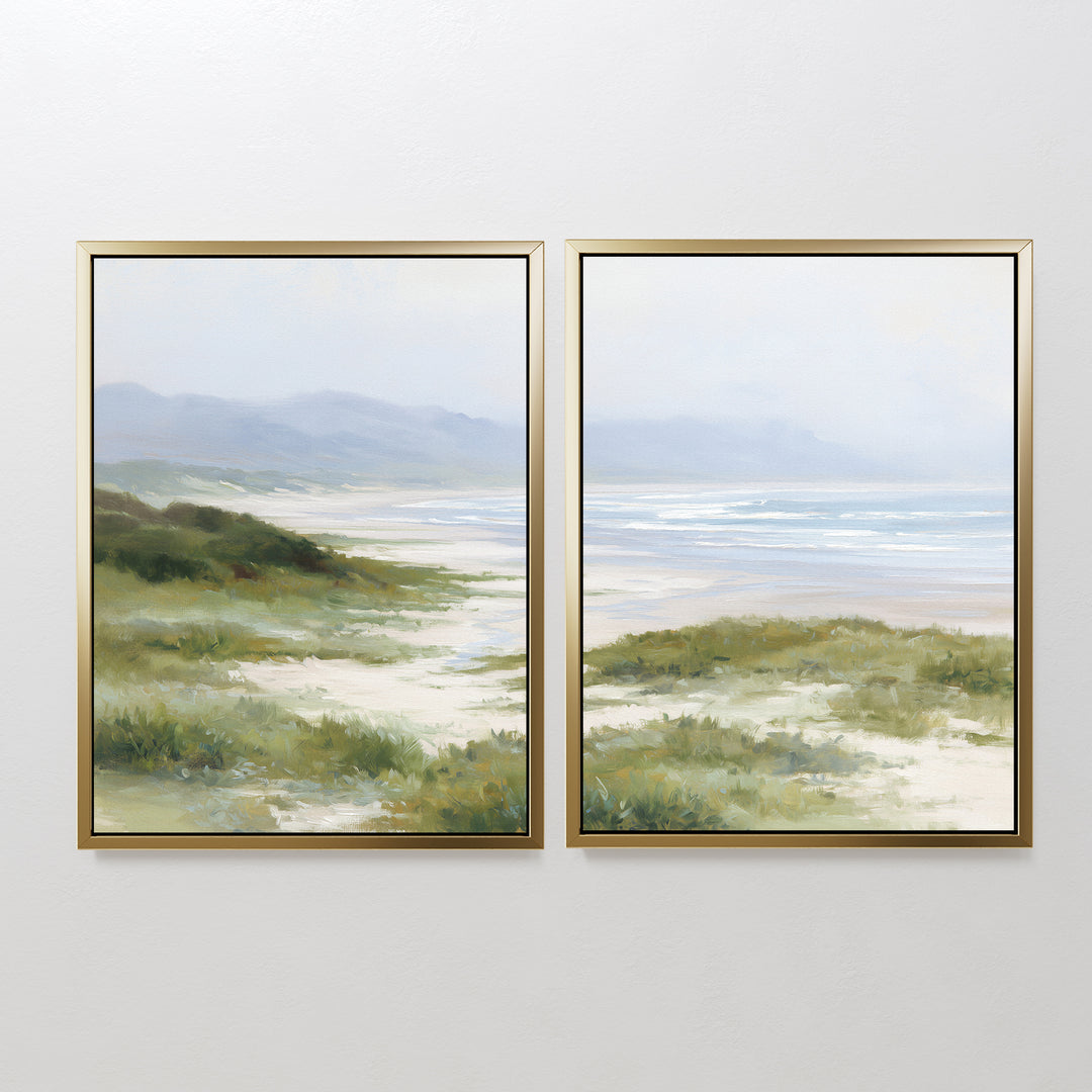 The "Windswept Dunes - Set of 2" framed canvas prints feature serene coastal grasslands, dunes, and a distant ocean under a cloudy sky, bringing a calming vibe to any plain white wall.